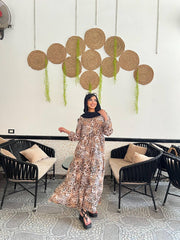 Woman wearing an animal print viscose maxi dress with a relaxed fit, styled with a black hijab and sunglasses.