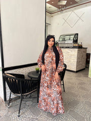 Woman wearing an animal print viscose maxi dress with a relaxed fit, styled with a black hijab and sunglasses.