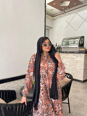 Woman wearing an animal print viscose maxi dress with a relaxed fit, styled with a black hijab and sunglasses.
